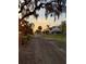 Residential street at sunset with houses and trees at 310 Lake Ave, Dundee, FL 33838