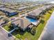 An aerial view of a community featuring a pool, water views, manicured lawns, and dedicated parking at 10421 Manderley Way # 268, Orlando, FL 32829