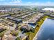 Aerial view of a community featuring a clubhouse, swimming pool, and surrounding lakes at 10421 Manderley Way # 268, Orlando, FL 32829