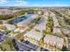 Aerial view showcasing community with beautiful landscaping, pond, and convenient parking at 10421 Manderley Way # 268, Orlando, FL 32829