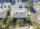 Aerial view of building featuring lush landscaping and abundant parking at 10421 Manderley Way # 268, Orlando, FL 32829