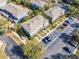 Aerial view of townhomes showcasing a beautiful landscape, parking spots, and a green location pin at 10421 Manderley Way # 268, Orlando, FL 32829