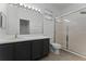 Bathroom featuring vanity with sink, large mirror, and enclosed glass door shower at 10421 Manderley Way # 268, Orlando, FL 32829