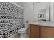 A well-lit bathroom features a black and white shower curtain, a toilet, and vanity at 10421 Manderley Way # 268, Orlando, FL 32829