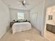 Bright bedroom featuring a queen-sized bed, ceiling fan, and an en suite bathroom at 10421 Manderley Way # 268, Orlando, FL 32829