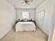 Bedroom boasts a queen-sized bed, ceiling fan, carpet, and neutral paint at 10421 Manderley Way # 268, Orlando, FL 32829