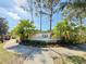 Landscaped community entrance sign with colorful flowers and palm trees at 10421 Manderley Way # 268, Orlando, FL 32829