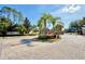View of the gated community entrance with lush landscaping and brick paved roads at 10421 Manderley Way # 268, Orlando, FL 32829