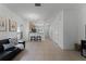 A spacious living room with an adjacent staircase, modern lighting and an open-concept design at 10421 Manderley Way # 268, Orlando, FL 32829