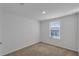 This bedroom features neutral carpet, light walls, and a window at 12043 Holystone St, Winter Garden, FL 34787