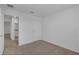 This bedroom features neutral carpet and a door to the bathroom at 12043 Holystone St, Winter Garden, FL 34787