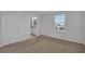 This bedroom features neutral carpet and a bathroom at 12043 Holystone St, Winter Garden, FL 34787