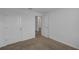 This bedroom features neutral carpet, crisp white walls and trim, with a bathroom through the doorway at 12043 Holystone St, Winter Garden, FL 34787