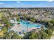 An aerial shot showcases a resort-style pool as a central feature of a thriving residential community at 12043 Holystone St, Winter Garden, FL 34787