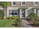 Inviting townhome entrance with meticulous landscaping and a charming brick path at 12043 Holystone St, Winter Garden, FL 34787