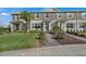 A well-maintained townhome featuring a brick walkway, manicured lawn, and charming curb appeal at 12043 Holystone St, Winter Garden, FL 34787