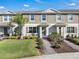 Attractive townhome featuring well-maintained landscaping and a welcoming brick walkway at 12043 Holystone St, Winter Garden, FL 34787