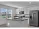 Modern kitchen featuring stainless steel appliances, granite countertops, and an island with a sink at 12043 Holystone St, Winter Garden, FL 34787