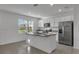 Bright kitchen featuring stainless steel appliances, granite countertops, island with sink, and ample cabinet space at 12043 Holystone St, Winter Garden, FL 34787