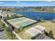 Well-maintained community tennis and volleyball courts near a serene lake, promoting active lifestyles at 12043 Holystone St, Winter Garden, FL 34787