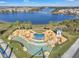 A stunning aerial view of the community's water feature and lakefront homes with lush landscaping and a luxurious design at 12043 Holystone St, Winter Garden, FL 34787