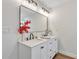 Bathroom vanity with double sinks, black fixtures, and a large mirror at 1245 13Th St, Orange City, FL 32763