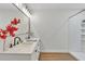 Bathroom vanity with double sinks, black fixtures, a large mirror, and adjacent walk-in shower at 1245 13Th St, Orange City, FL 32763