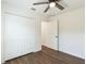 Bright bedroom with wood-look flooring, ceiling fan, and a double door closet at 1245 13Th St, Orange City, FL 32763