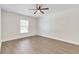 Bright bedroom featuring a ceiling fan, light hardwood floors, and natural light from the window at 1245 13Th St, Orange City, FL 32763
