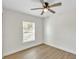 Bright bedroom featuring a ceiling fan, light hardwood floors, and natural light from the window at 1245 13Th St, Orange City, FL 32763