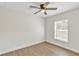 Bright bedroom featuring a ceiling fan, light hardwood floors, and natural light from the window at 1245 13Th St, Orange City, FL 32763