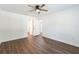 Spacious bedroom with wood-look floors, a ceiling fan, and a view into the walk-in closet at 1245 13Th St, Orange City, FL 32763