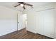 Bright bedroom with wood-look flooring, ceiling fan, and closet with bi-fold doors at 1245 13Th St, Orange City, FL 32763