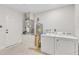 Garage laundry area with white washer and dryer, adjacent to water heater and utility connections at 1245 13Th St, Orange City, FL 32763