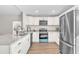 Bright kitchen with white cabinetry, stainless steel appliances, and granite countertops at 1245 13Th St, Orange City, FL 32763