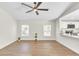 Spacious living room featuring wood-look flooring, complemented by an open layout into the kitchen at 1245 13Th St, Orange City, FL 32763