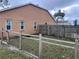 Fenced backyard with a small grassy area at 12826 Forestedge Cir, Orlando, FL 32828