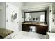 Spacious bathroom with granite countertops and a large mirror at 12826 Forestedge Cir, Orlando, FL 32828