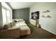 Living room with large sectional sofa and a wall-mounted TV at 12826 Forestedge Cir, Orlando, FL 32828