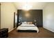 Large main bedroom with a king-size bed and dark accent wall at 12826 Forestedge Cir, Orlando, FL 32828