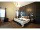 Spacious main bedroom with a king-size bed, dark accent wall and carpet flooring at 12826 Forestedge Cir, Orlando, FL 32828