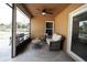 Relaxing screened porch with seating and ceiling fan at 12826 Forestedge Cir, Orlando, FL 32828