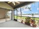 The screened porch has potted plants, a ceiling fan and sliding door access to both the living room and the view at 136 Carolwood Blvd, Fern Park, FL 32730