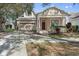 Attractive two-story house with a red door and landscaped yard at 13751 Eden Isle Blvd, Windermere, FL 34786