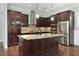 Kitchen with dark wood cabinets and granite island at 1525 Resolute St, Celebration, FL 34747