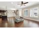 Hardwood floor living room, neutral walls, large windows at 1525 Resolute St, Celebration, FL 34747