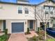 Townhouse exterior with gray garage door and brick walkway at 1578 Grand Rue Dr, Casselberry, FL 32707