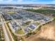 A Primary-planned community, boasting townhomes with garages and manicured landscaping near a lake and green spaces at 16521 Prairie School Dr, Winter Garden, FL 34787
