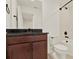 Bathroom vanity boasts dark granite countertop, with a tub and shower at 16521 Prairie School Dr, Winter Garden, FL 34787