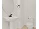 Modern bathroom featuring a sleek pedestal sink and toilet at 16521 Prairie School Dr, Winter Garden, FL 34787